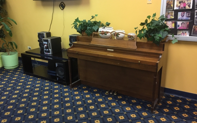 Martin Farrell House activity room with piano